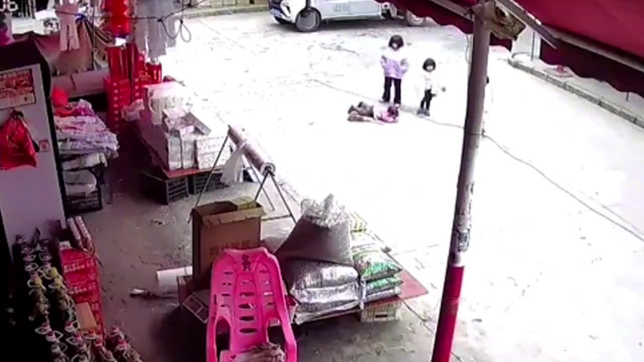 Video - Clip: Bé gái nằm giữa đường bị cán trúng, mẹ hoảng sợ đập kính xe ô tô